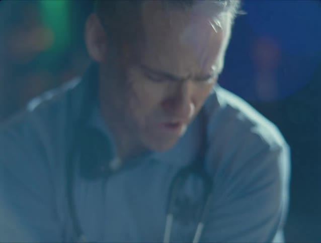 A doctor struggles to resuscitate a person during an emergency outside