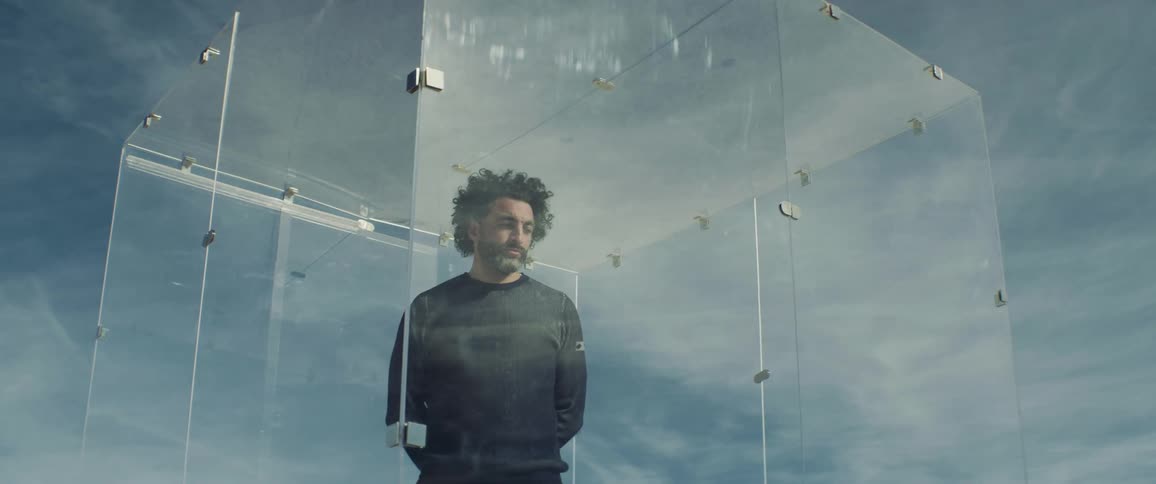 A man is trapped in a glass cage