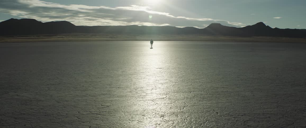 A person is walking in the desert