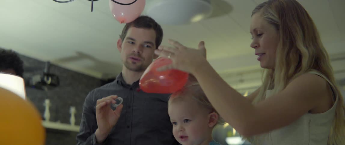 Heartwarming domestic scene of a young child and adults enjoying a festive holiday event.