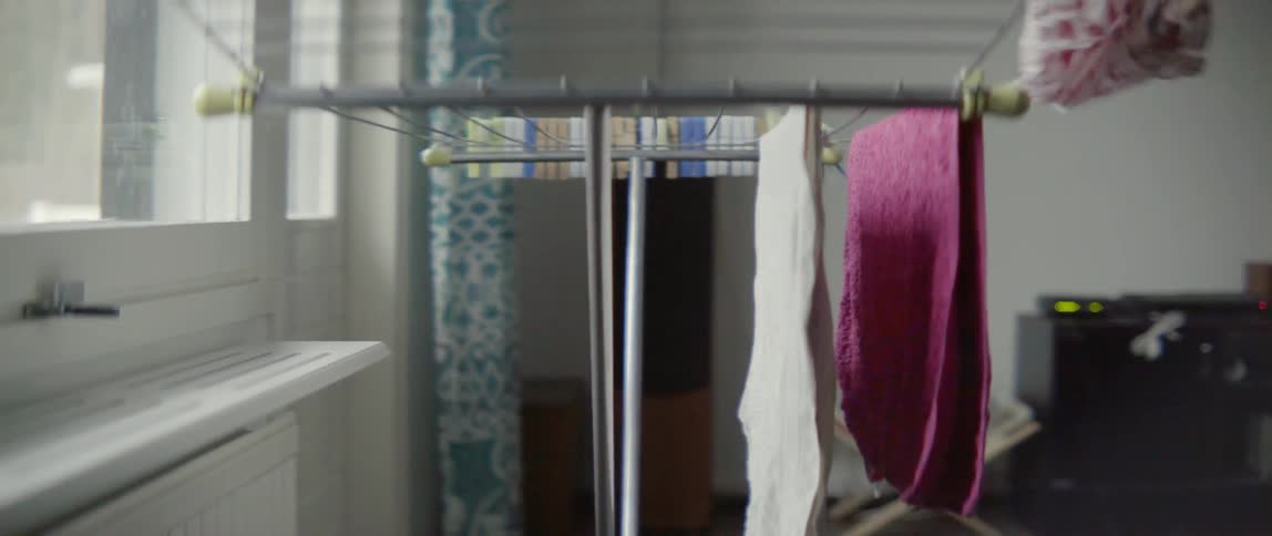 A person is hanging clothes to dry on a hanger