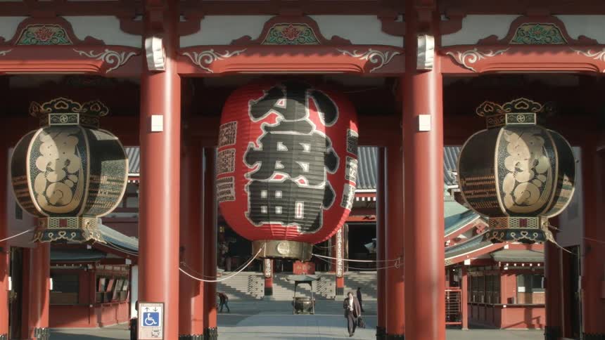 Lanterns with chinese characters hang from a building