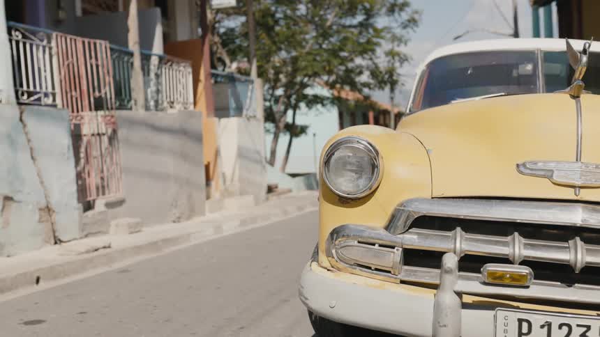 A view of the outdoors in the summer time and a taxi is on the side