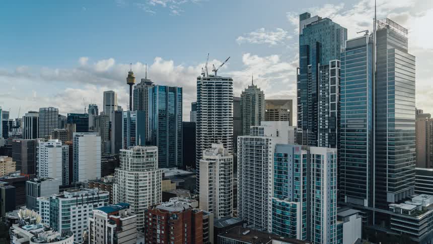 Clouds pass over the tall buildings and skyscrapers in a metropolis during the day