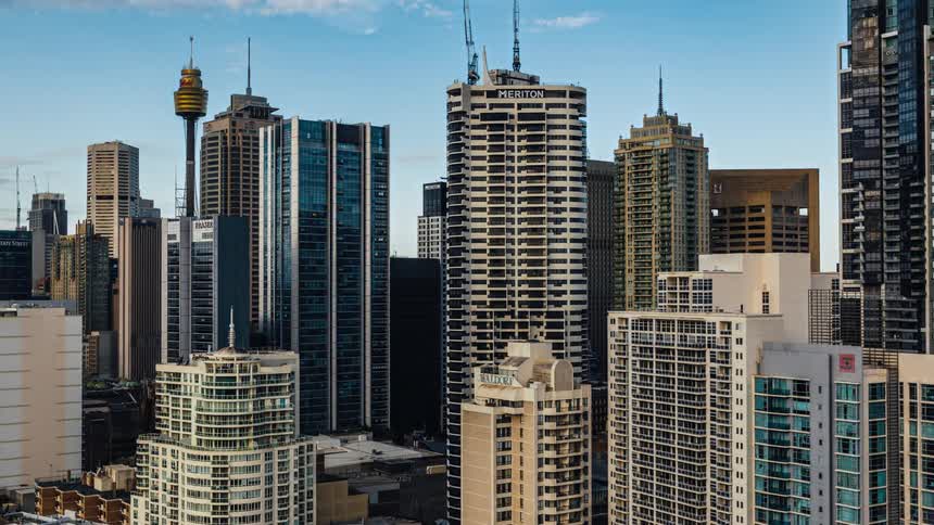 Clouds floating over tall skyscrapers in a city