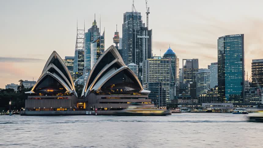 A view is of the city that is surrounded by buildings and water