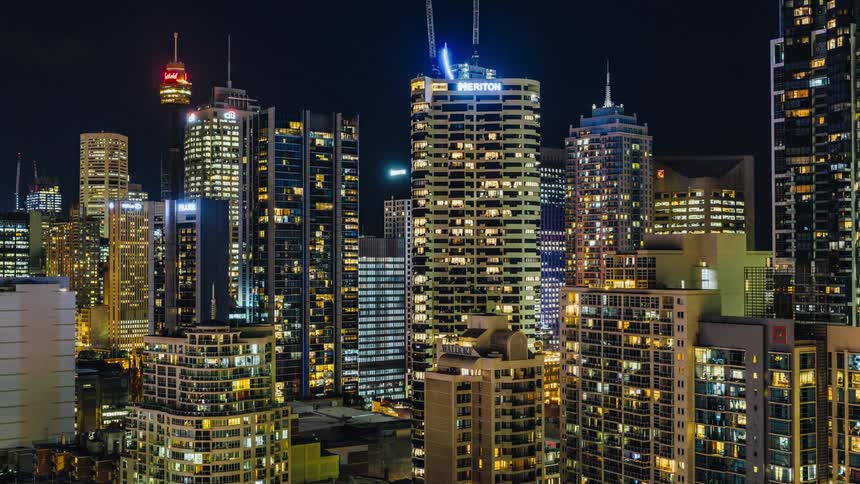 City lights in downtown skyscrapers come on as night falls