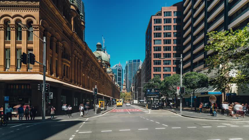 Cars and pedestrians traveling on a busy city street