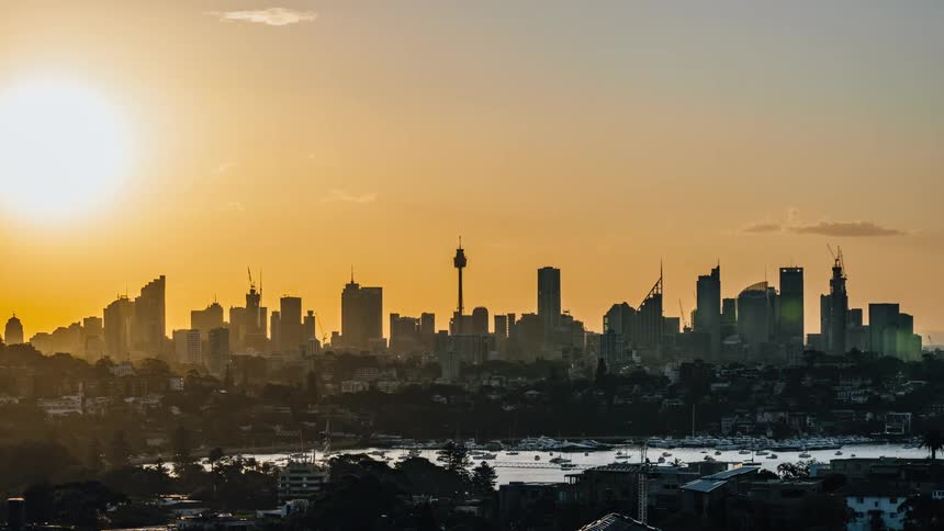 Time lapse view of a city skyline at dusk is displayed