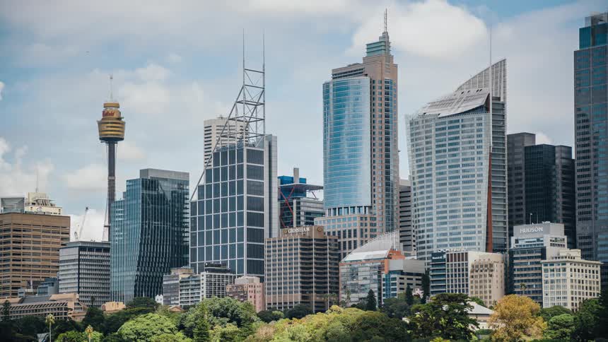 Clouds floating above tall skyscrapers in a city
