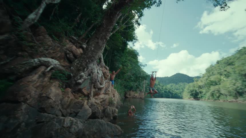 A group of people are hanging out around the lake