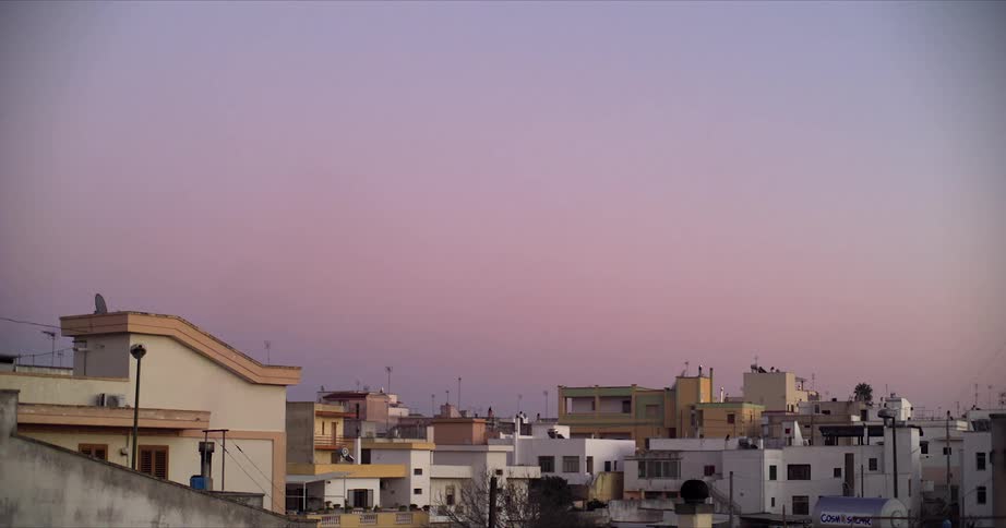 Aerial view of a downtown city at dusk is displayed