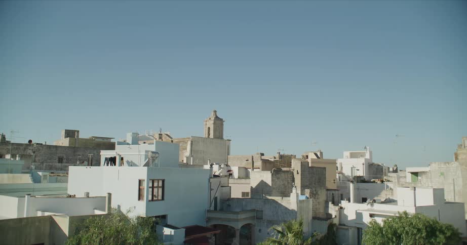 White and tan buildings on a clear day