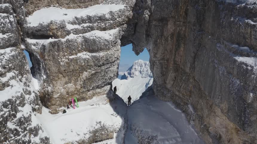Aerial view of people skiing on a mountain in winter