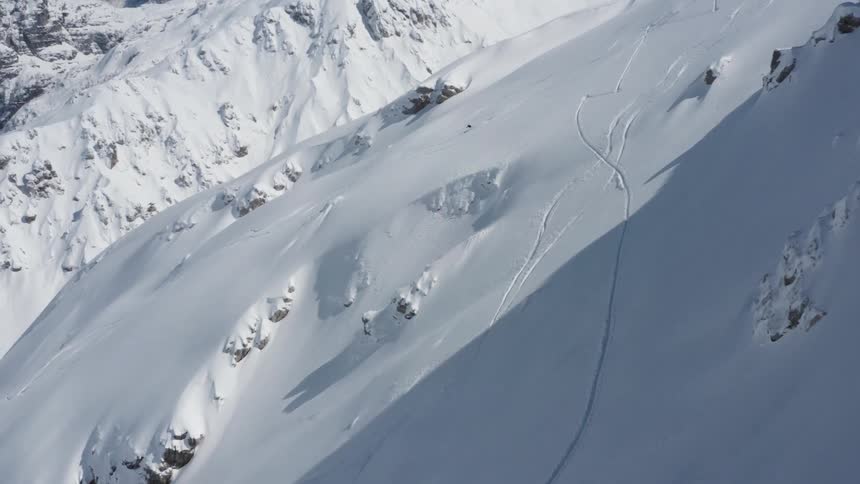 A person is skiing down a mountain during the winter season