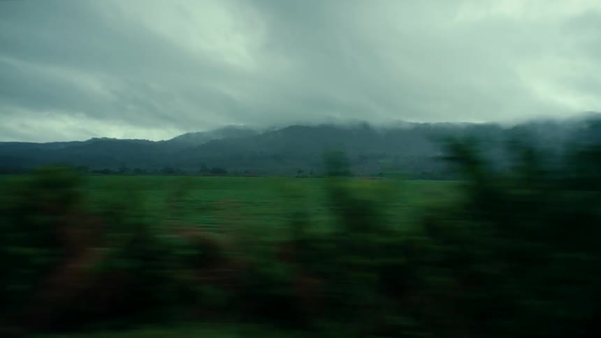 A large field in the countryside under a cloudy daytime sky
