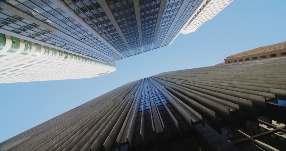 A pair of skyscrapers opposite one another in a metropolis during the day