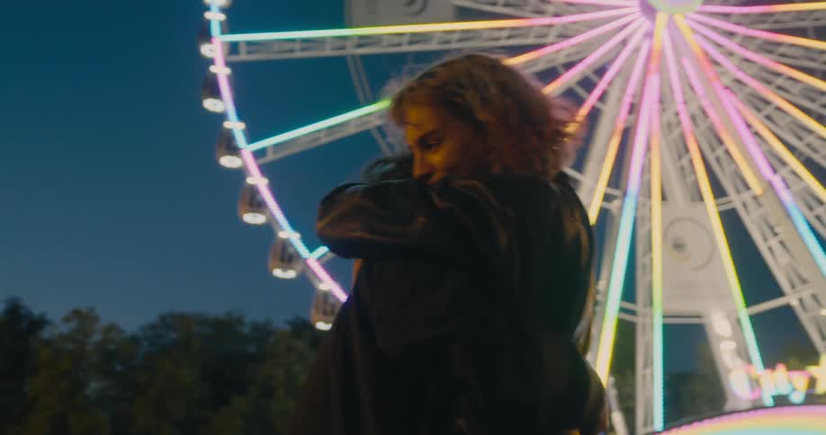 Young women are hugging at a carnival