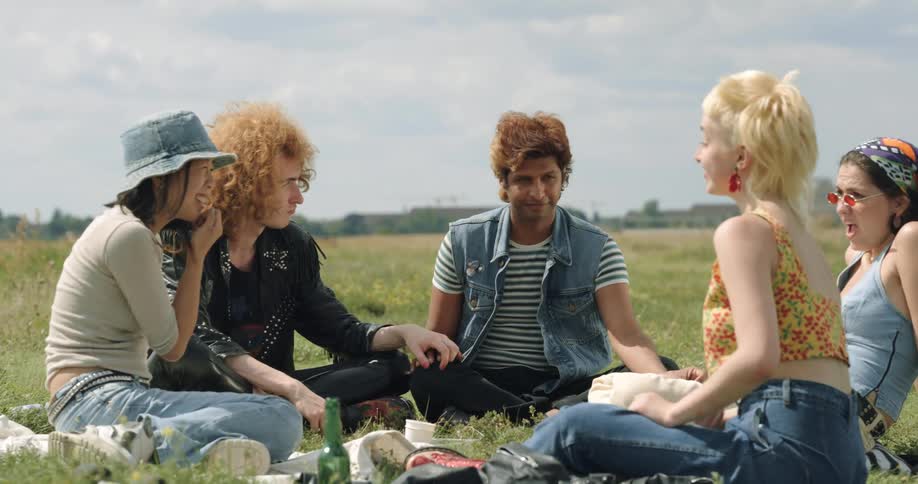 A group of friends are talking to each other outdoors in spring