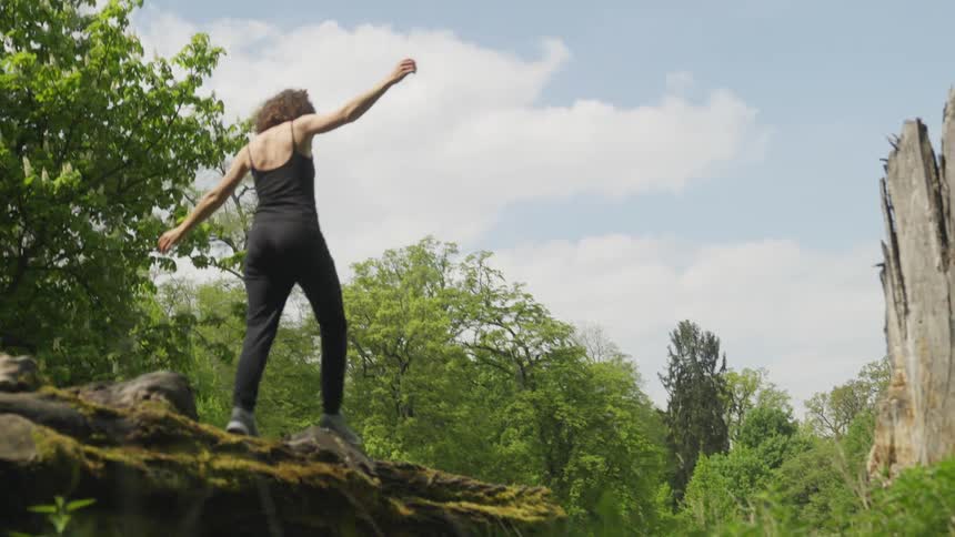 A woman is hiking outdoors during the spring time