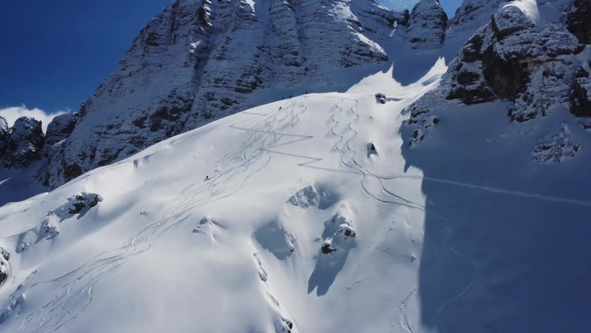 An aerial view of a mountain covered in snow
