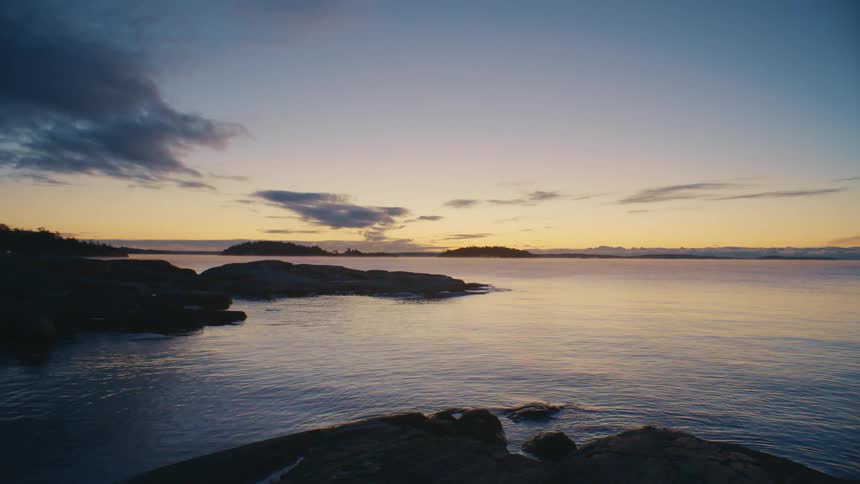 The sun is setting in the horizon of ocean water