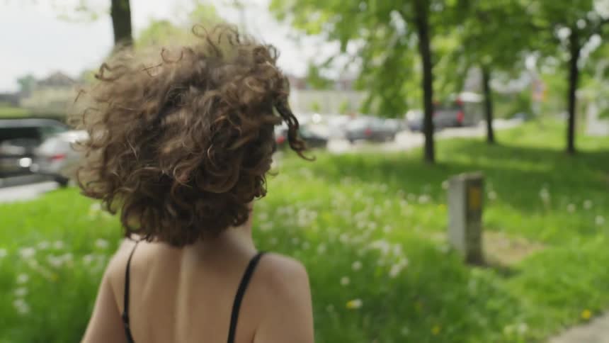 A woman is jogging outdoors during the spring time