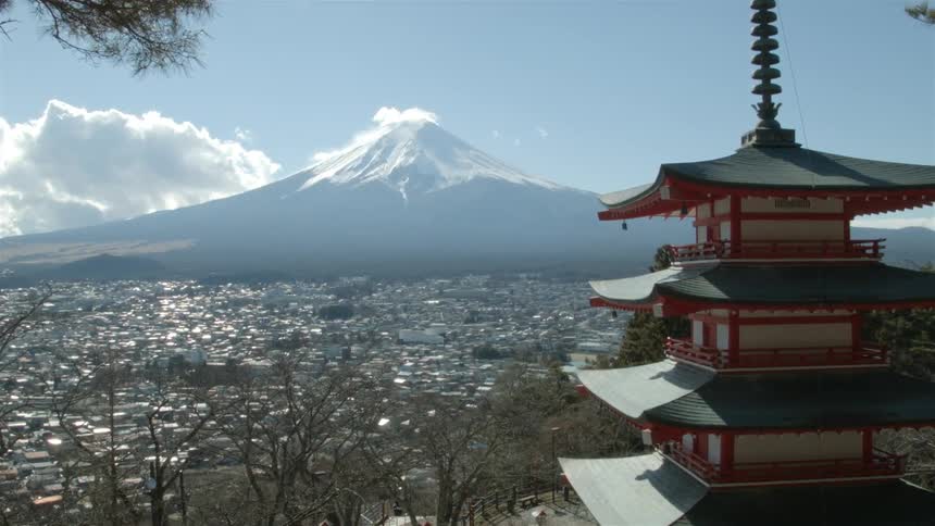 A large city at the base of a mountain during the day