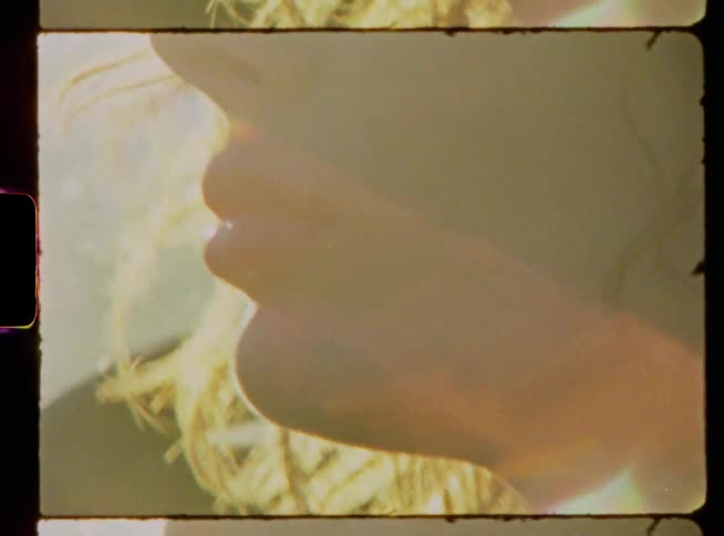 A woman with hair being blown by the wind turns her head