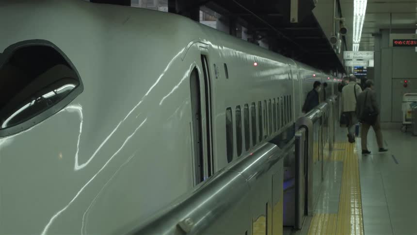 A train stops and people step out