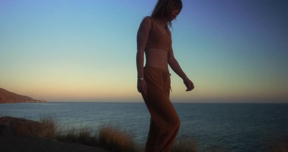A woman walking along the coast