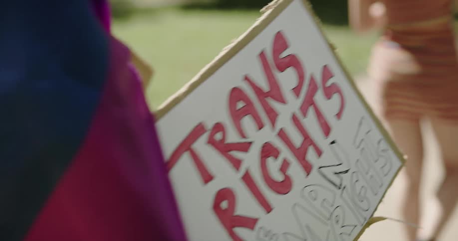 People are protesting holding a sign outside
