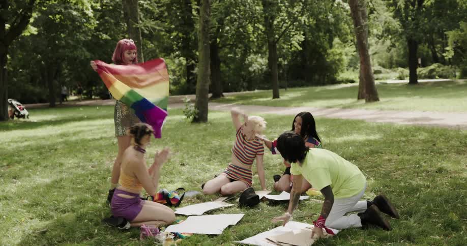 A group of friends are outside hanging out at the park