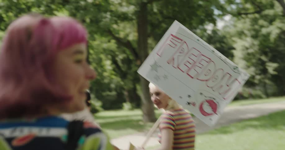 A group of women are protesting outdoors during the spring time