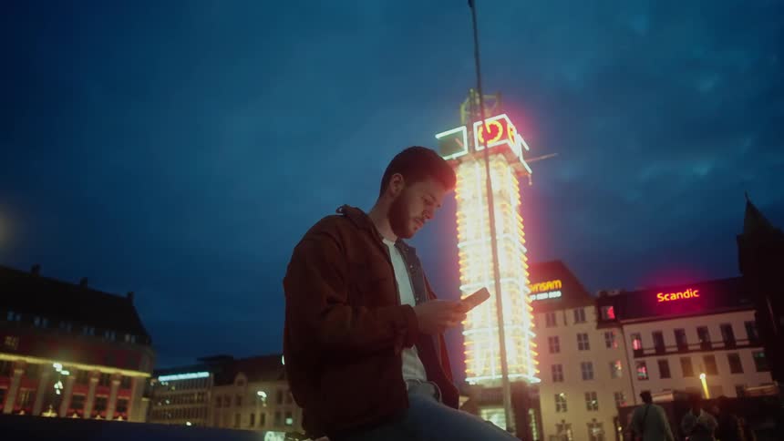 A man is downtown on his phone outside