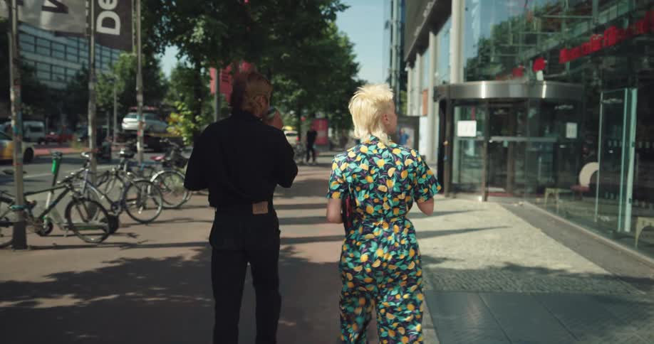 Man and woman are walking through a downtown city together
