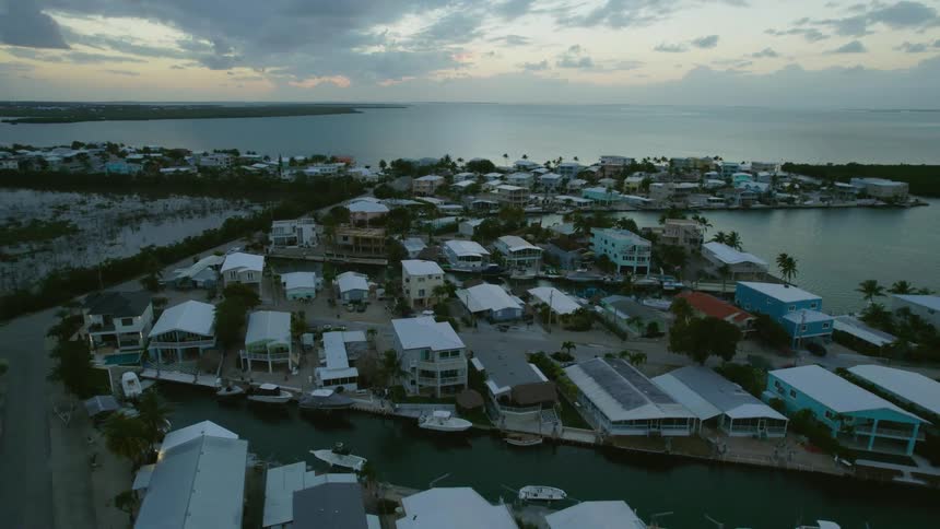 An aerial view of a small harbor at sunrise