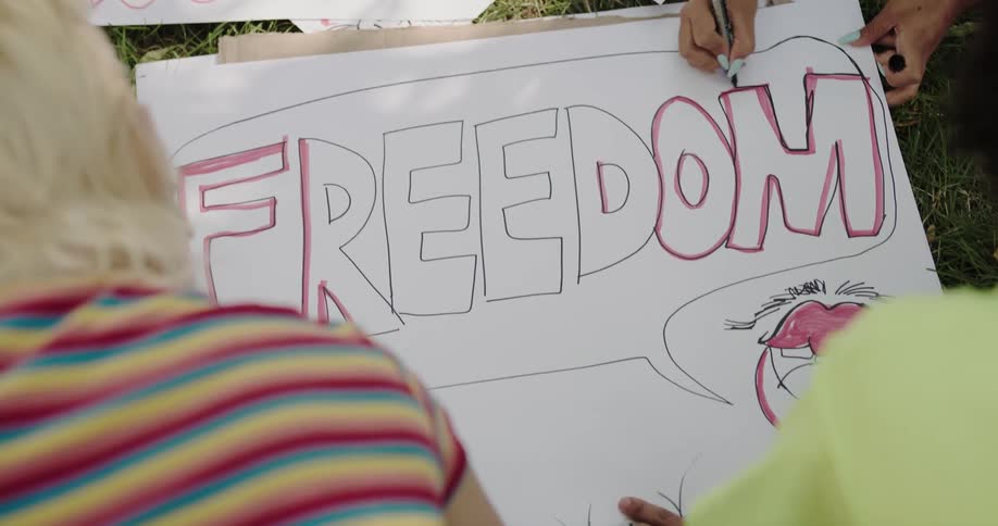 People are drawing signs in the grass