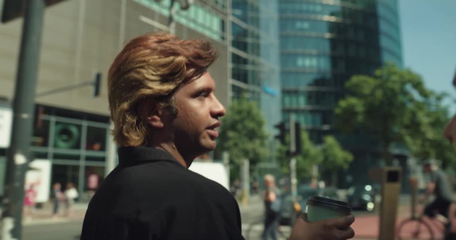 Two friends are walking outside downtown in the day time