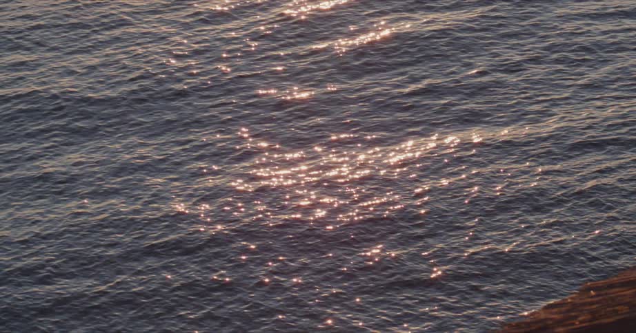Sunlight shines on water as it ripples and waves