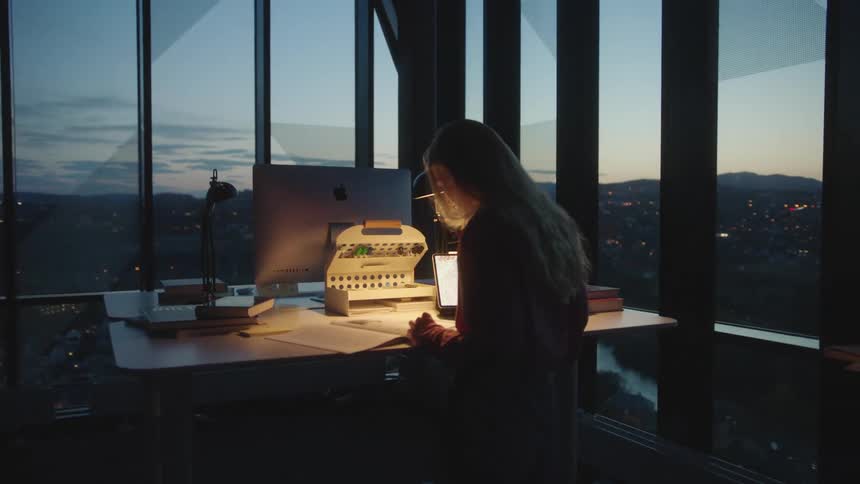 A woman is sitting in her office in a downtown city