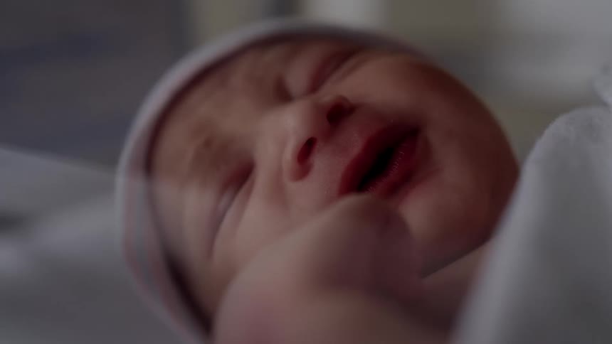 Cute newborn covered with a blanket sleeping