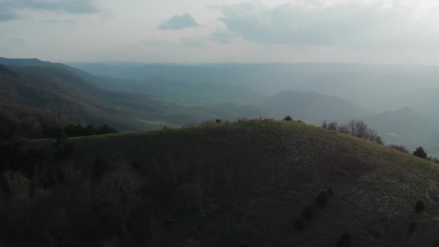 A mountainous countryside covered in mist during the day