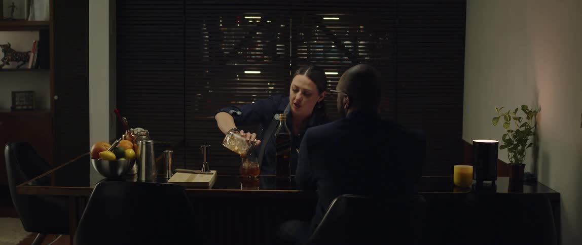 Bartender serve prepared drink to customer as she talks