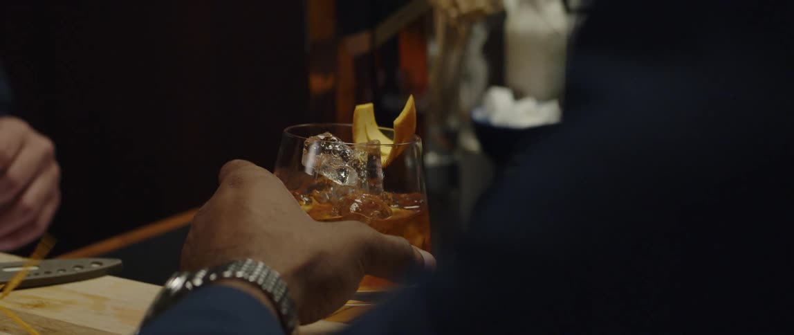Man and woman are at the bar counter together and drinking