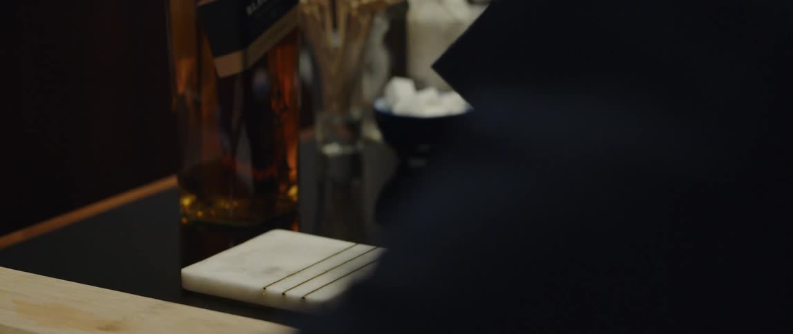 A person is drinking an alcoholic beverage in a bar