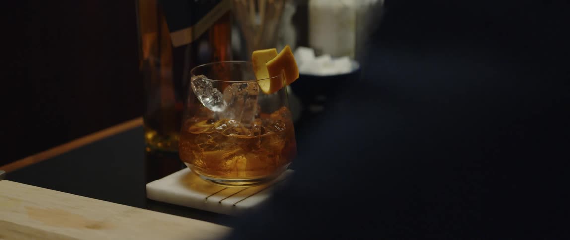 A person is getting served drinks at the bar counter