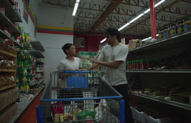 A pair of brothers play around while shopping in a grocery market