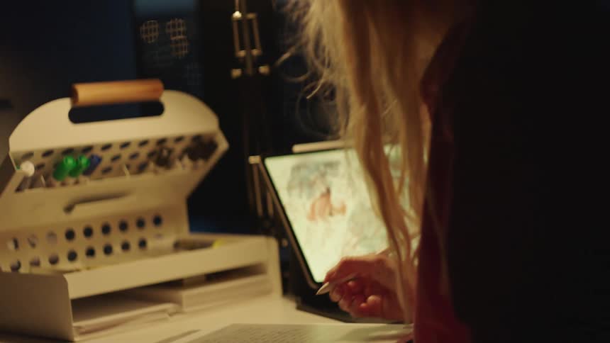 A young woman takes extensive notes while studying in a lab