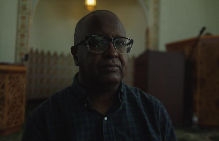 Man sits in richly decorated mosque